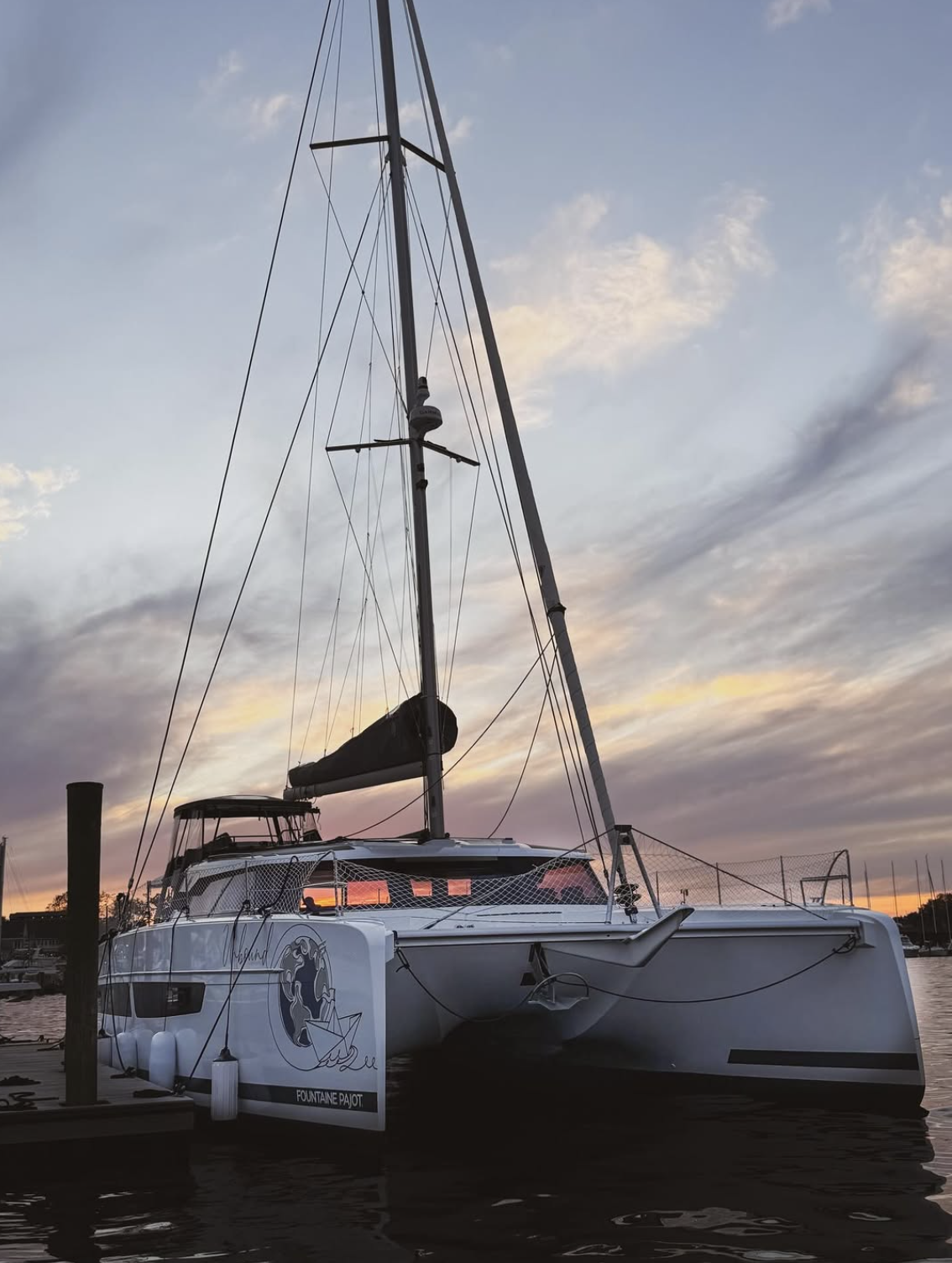 SV Unbound at the dock beneath a sunset sky.